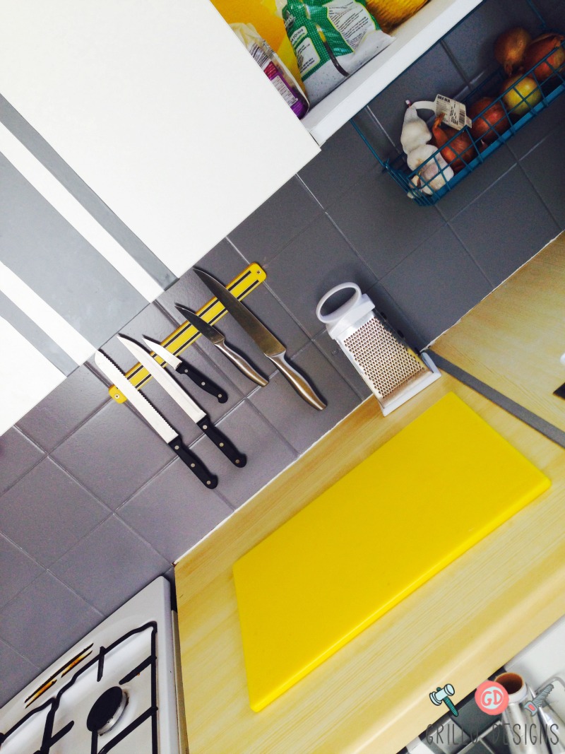 Black tiles painted gray and a magnetic knife rack added