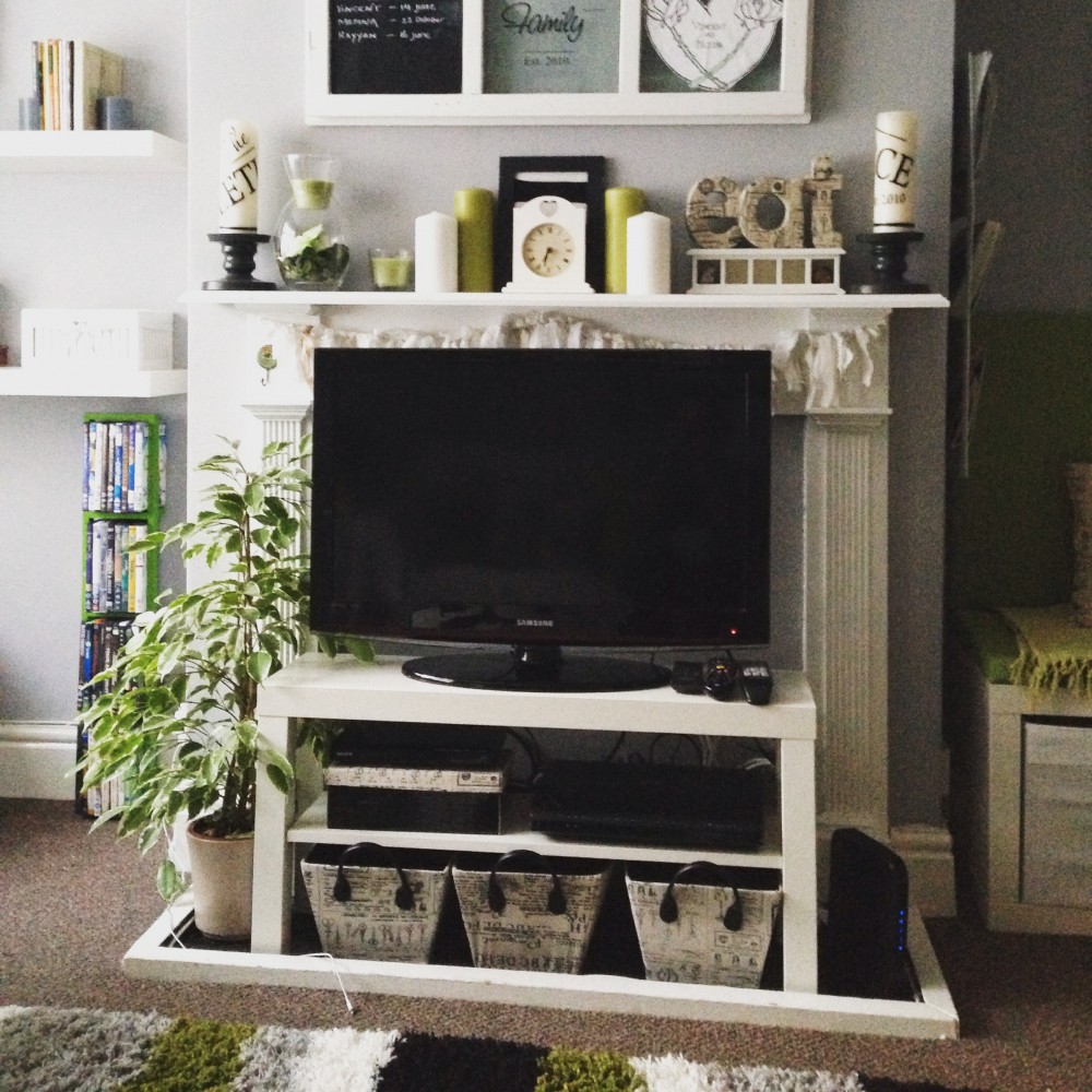 Ikea lack bench as a TV stand in front of a fireplace