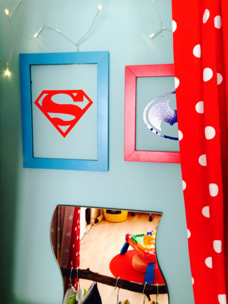 Framed superhero logos in the dress up area