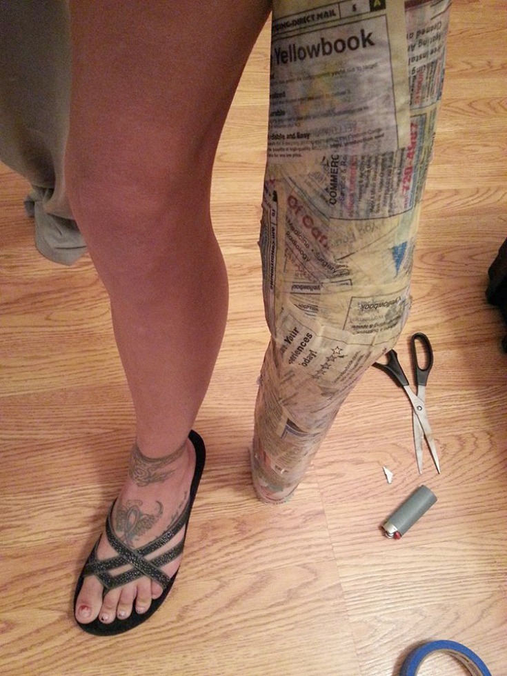 Covering the fake leg with newspaper and mod podge