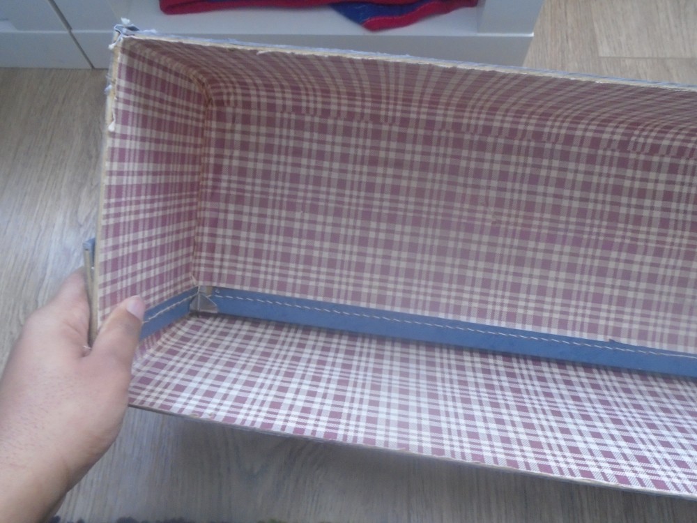 Inside view of a suitcase cut in half as it is turned into a diy suitcase shelf