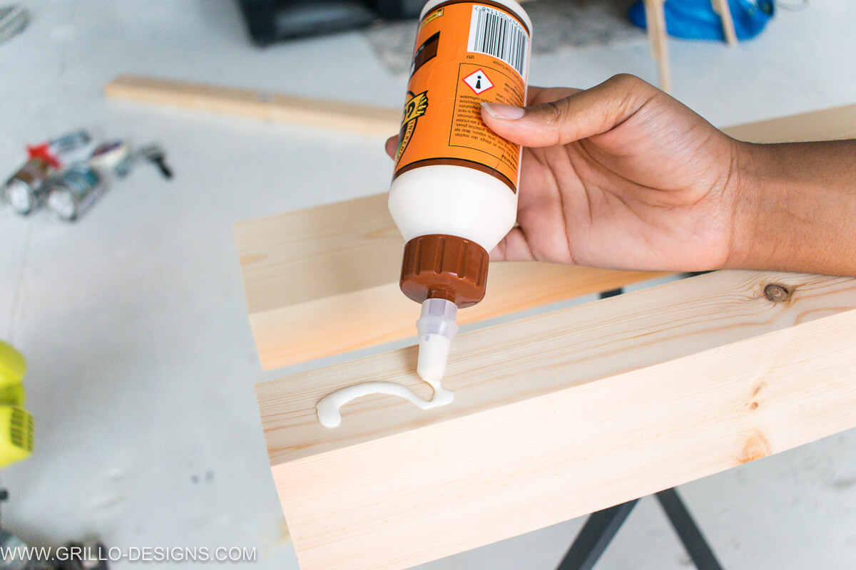 Apply wood glue to one side of the wooden planks to make the table top for the overbed table