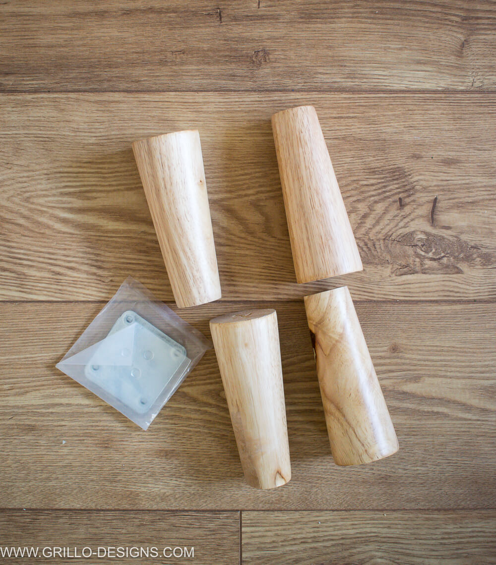 four wooden legs placed on the laminate flooring 