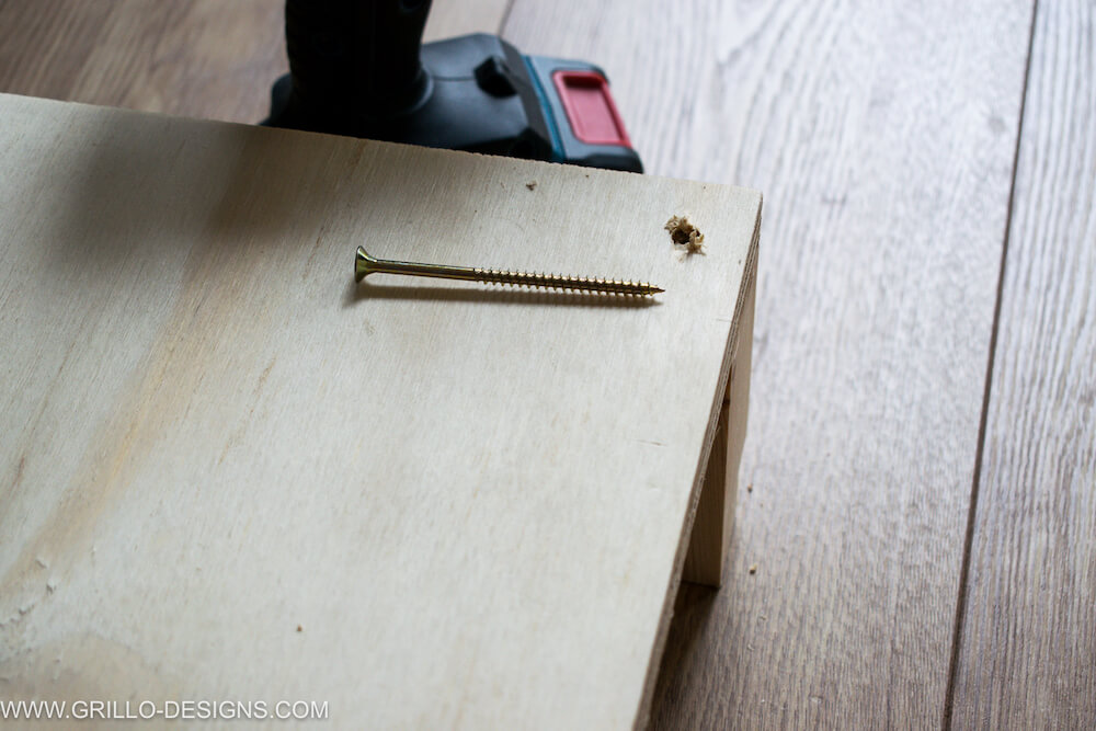 Image of screw on wooden platform with pre- drilled hole 