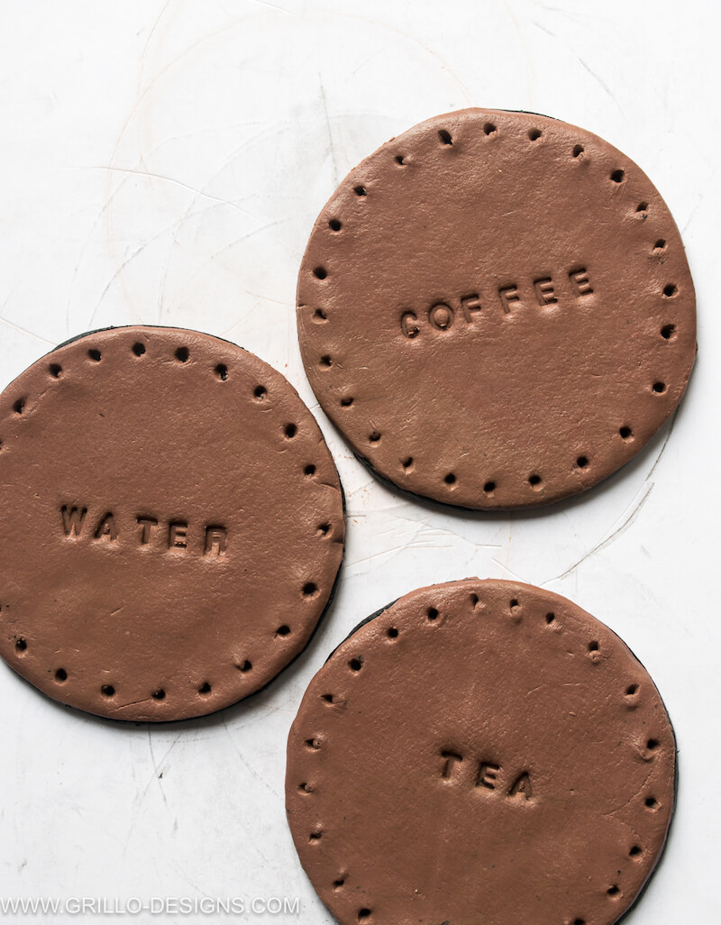 Leather coasters with the words tea, coffee and water engraved