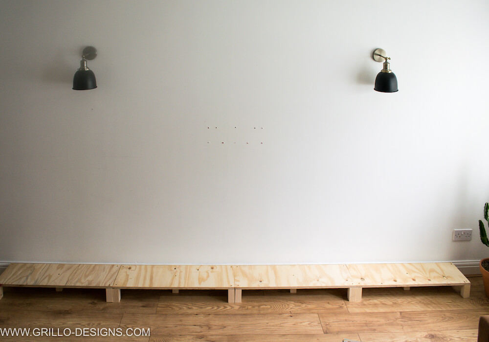 Picture of the wooden platform against the white living room wall
