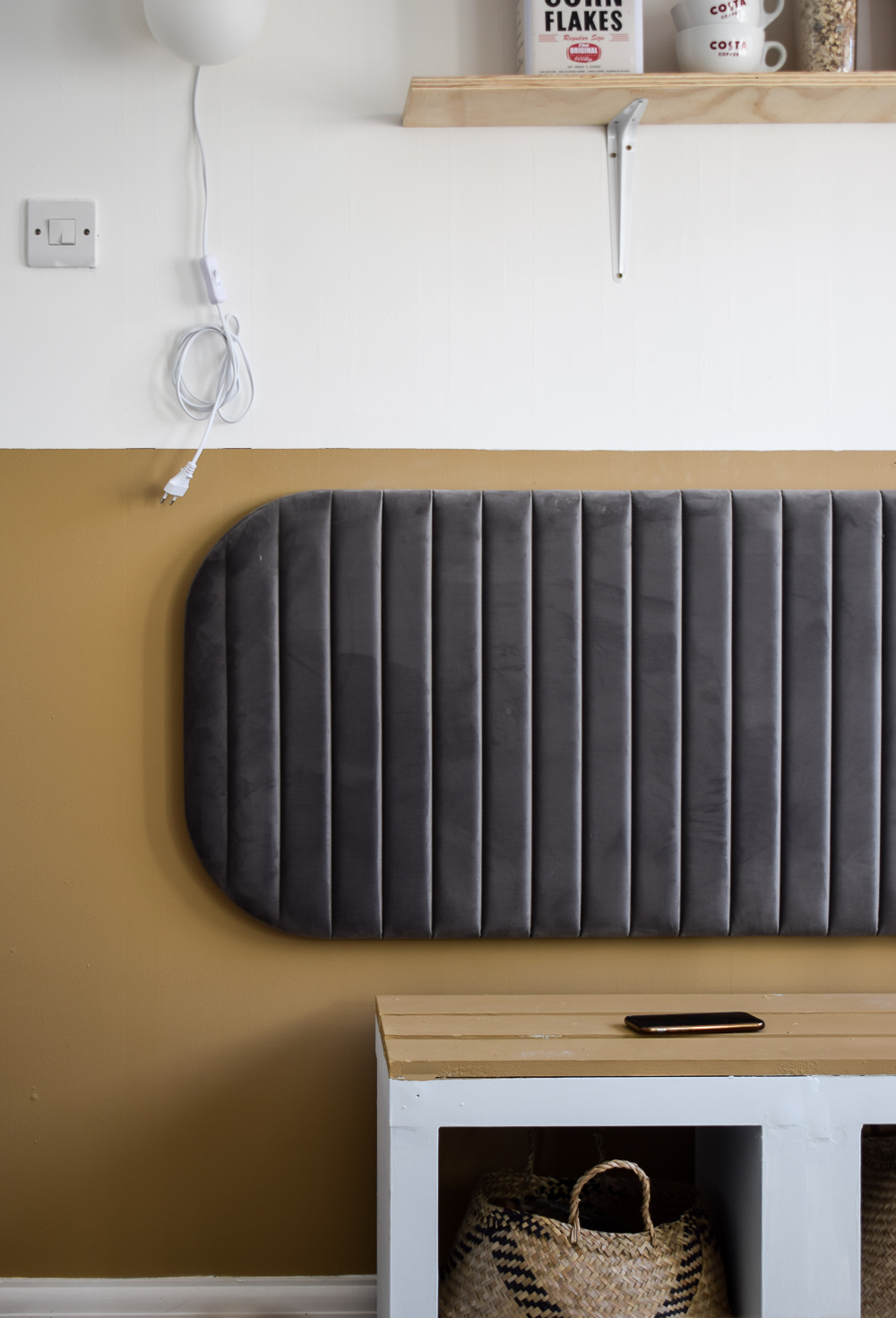 The next home velvet head board applied to the wall above the kallax bench