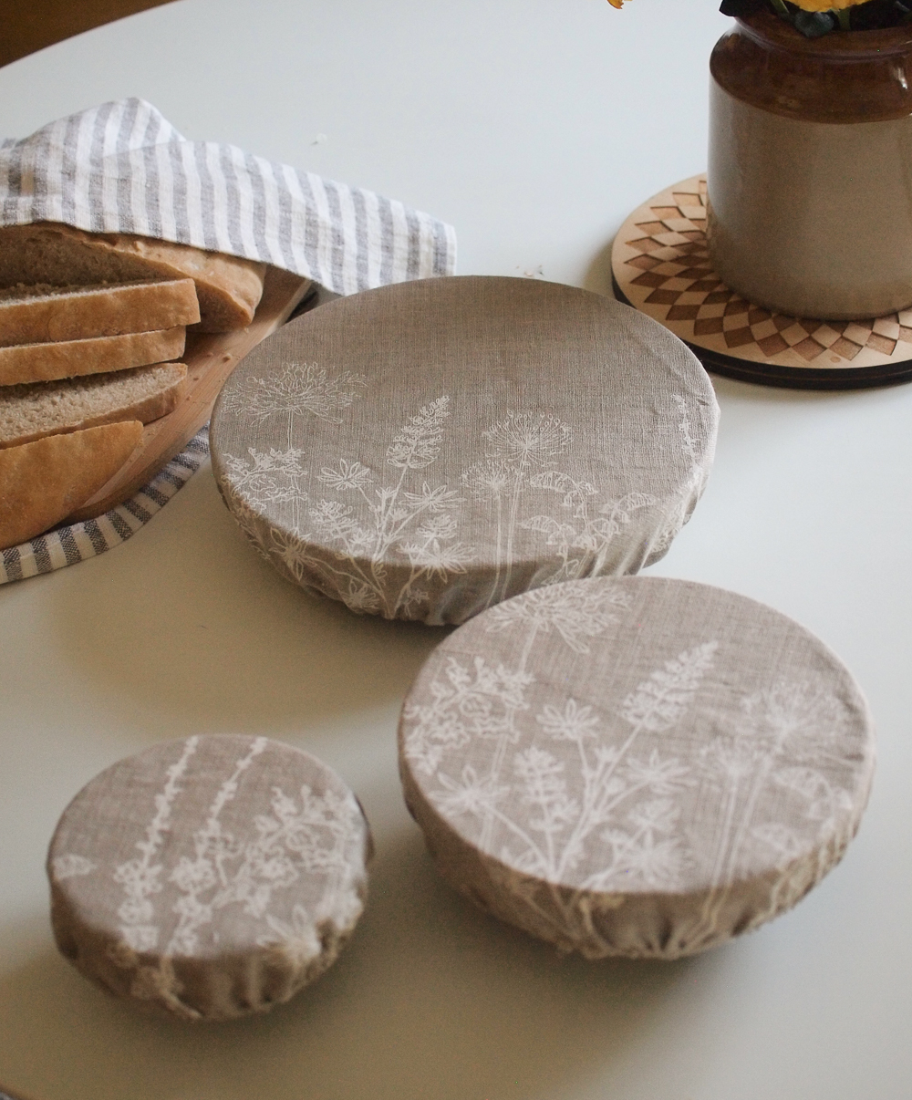 Set of three re-usable bowl covers on table