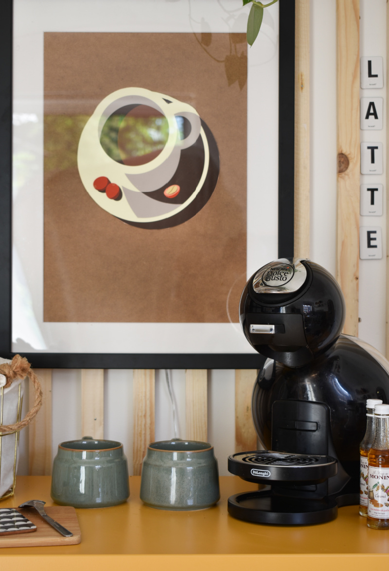 close up diy coffee station coffee machine stoneware mugs with neutral wall art