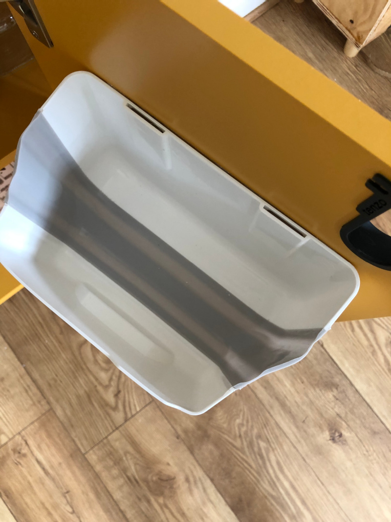 close up inside yellow diy coffee station cabinet and self adhesive recycling bin