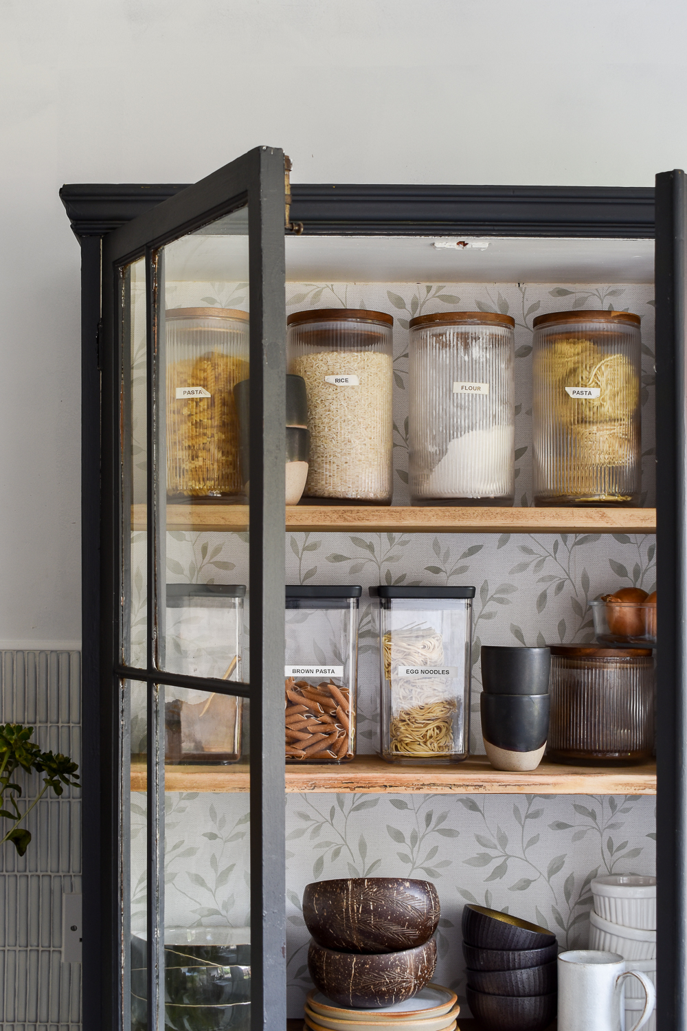 diy kitchen pantry with doors open so you can see items on shelves 