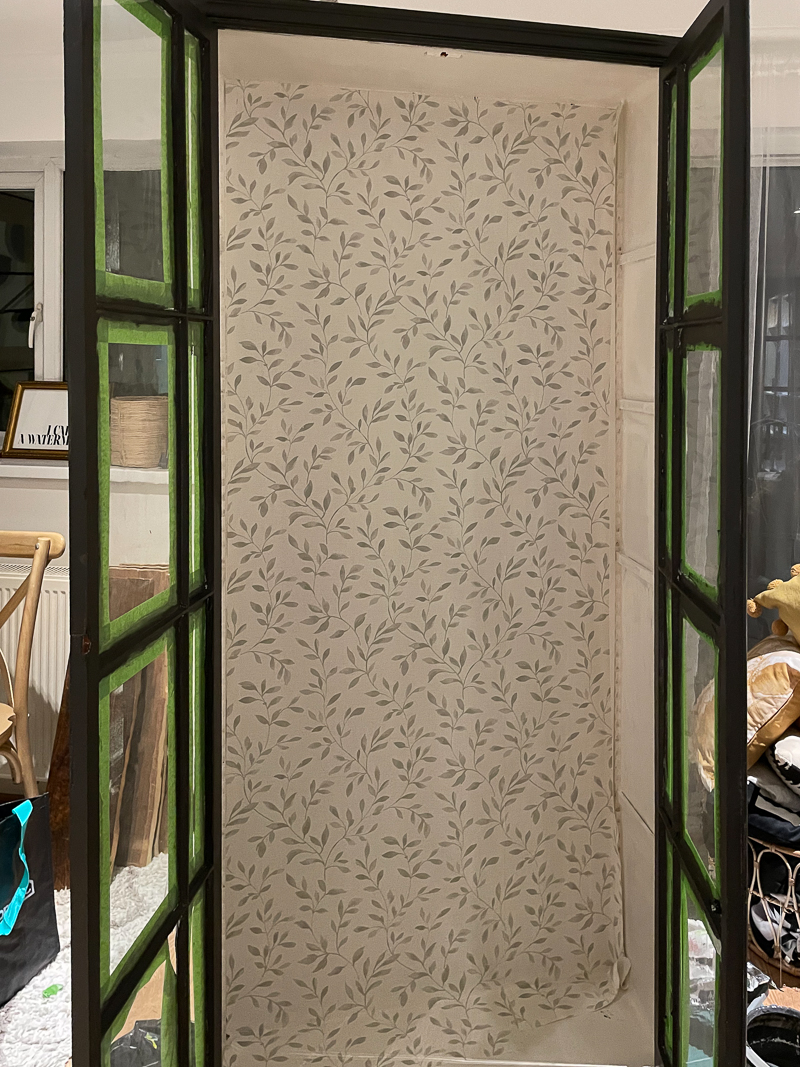Cabinet with leaf wallpaper applied to the inside 