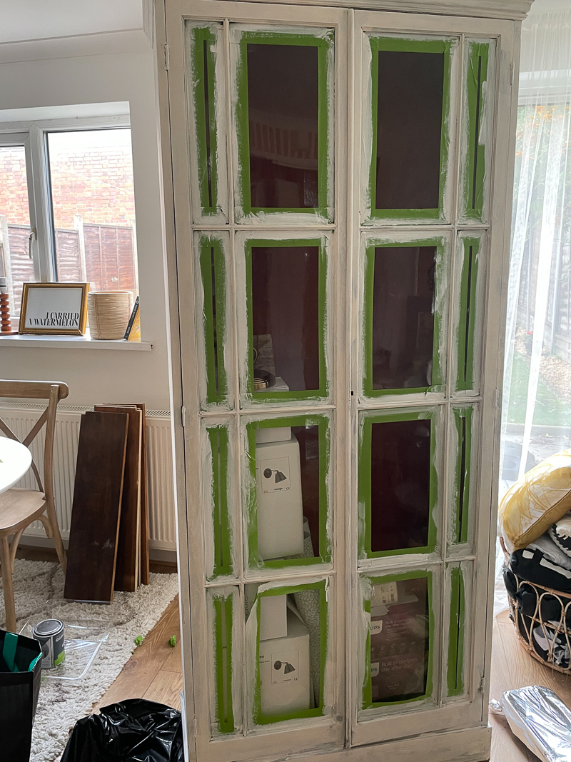 vintage cabinet in dining room with one coat of primer 