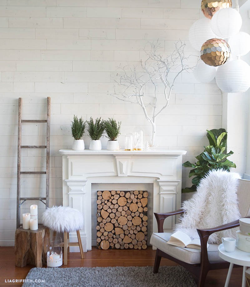 White faux mantle with stacked logs inside 