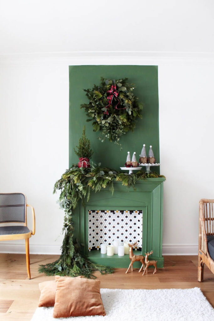 green painted fireplace with green painted accent wall above