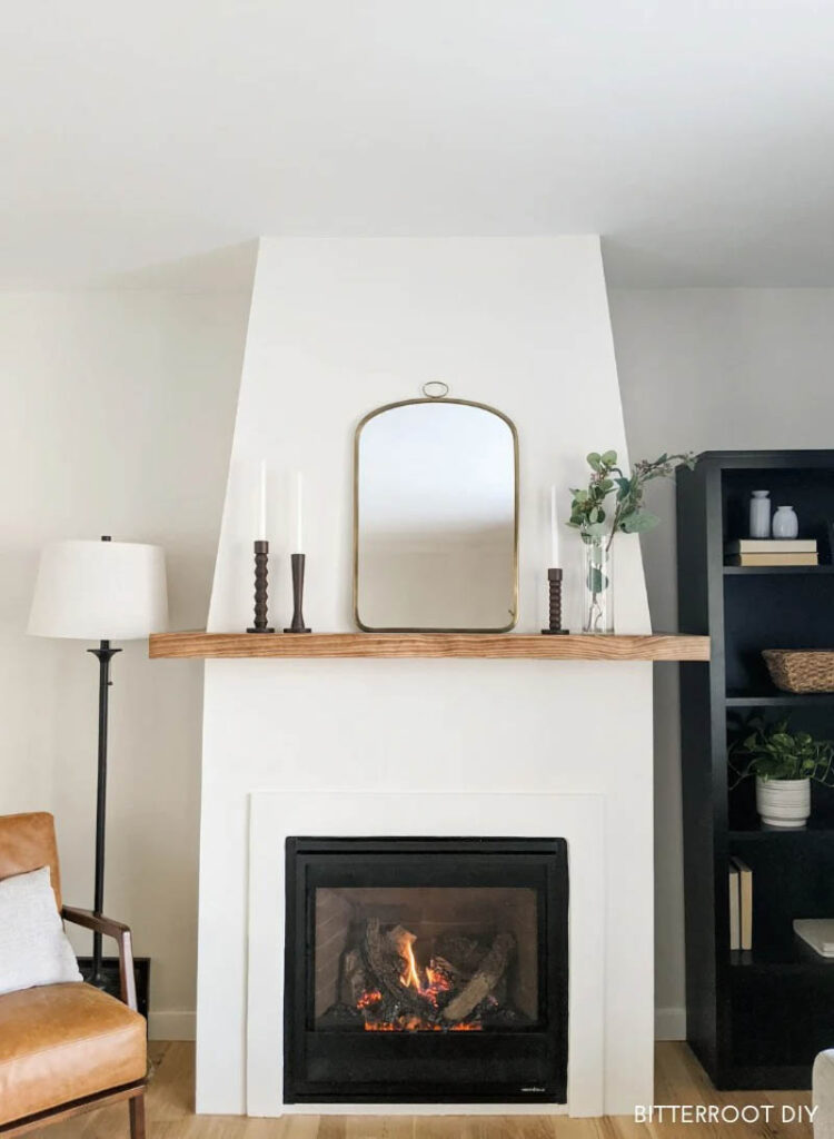 white modern fireplace with gas insert and wooden mantle in livingroom
