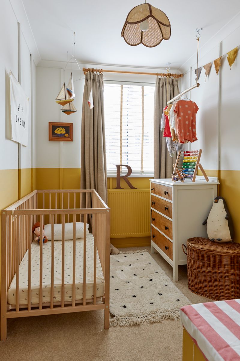 A look at the whole small nursery reveal, showing the wall, the cot, the rail and all furnishings
